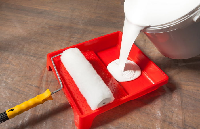 pouring paint into a tray