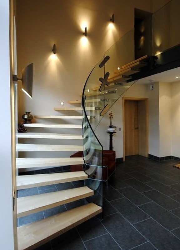 stairs with wall sconces in the interior of the house