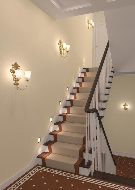 stairs with wall sconces in the interior of the house