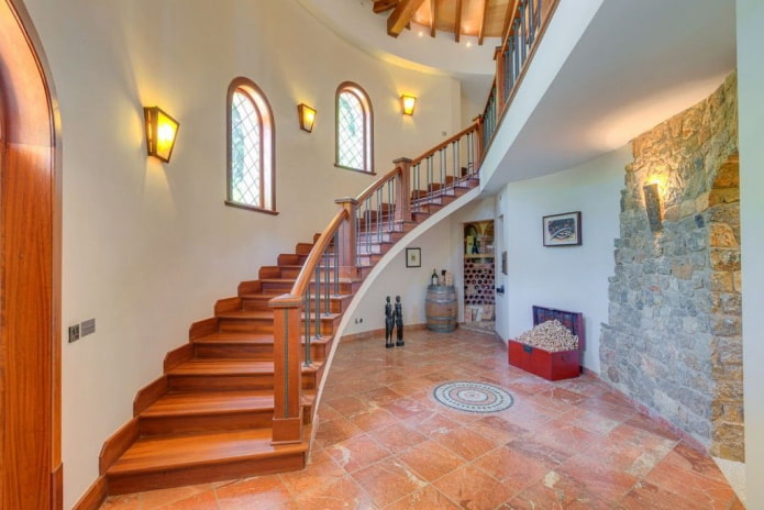 stairs with wall sconces in the interior of the house