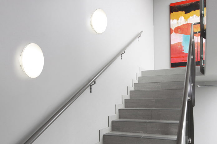 stairs with wall lamps in the house