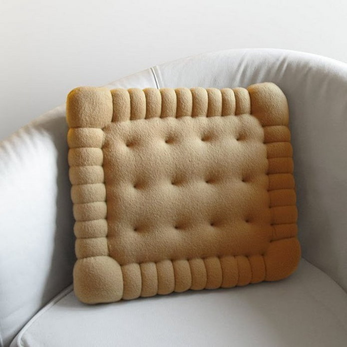unusual pillow in the shape of a cookie