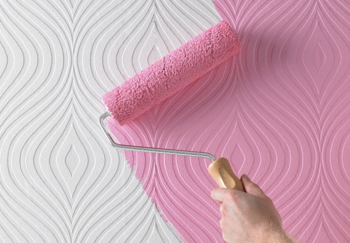 painting wallpaper with a roller