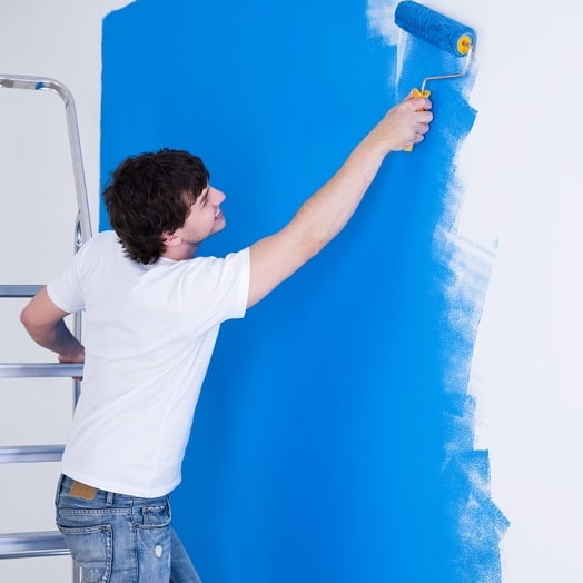 Painting a wall with a roller