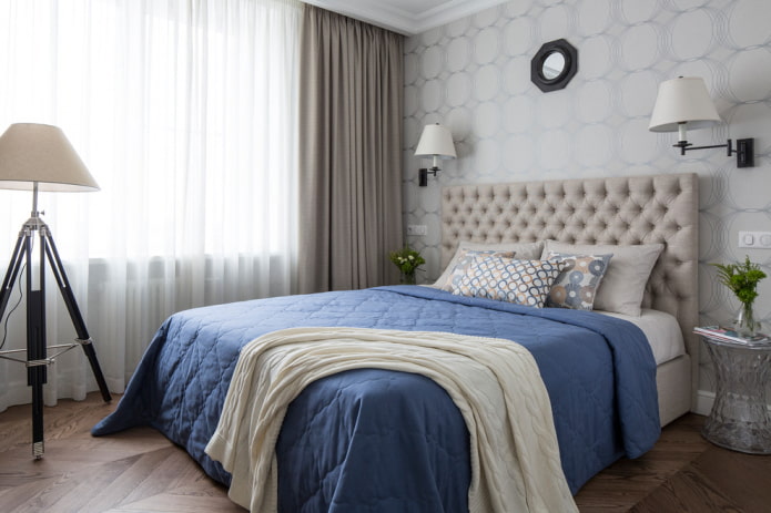 bed with a blue bedspread in the bedroom