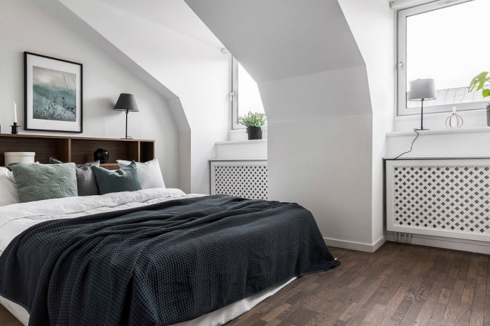 bed with a black bedspread in the bedroom