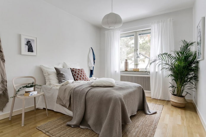 bed with gray bedspread in the bedroom