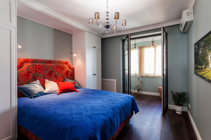 bed with blue bedspread in the bedroom