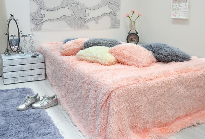 bed with a bedspread with pile in the bedroom