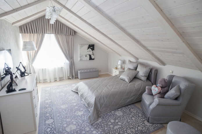 bed with gray bedspread in the bedroom