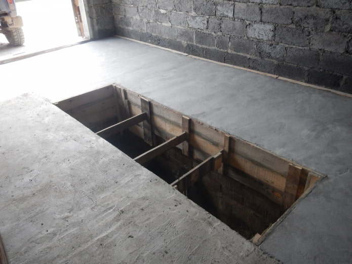 concrete floor in a garage with a pit