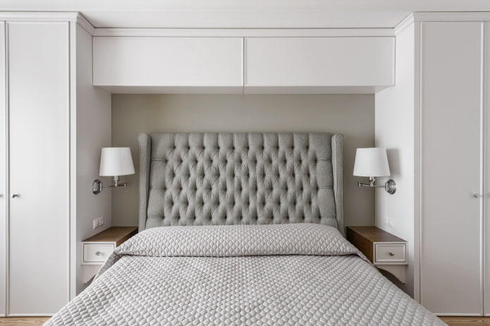 closed shelves above the bed in the interior