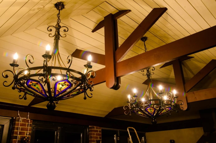 forged chandeliers on a wooden ceiling