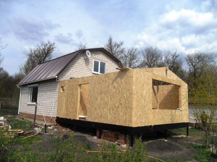 extension to a concrete house made of SIP panels