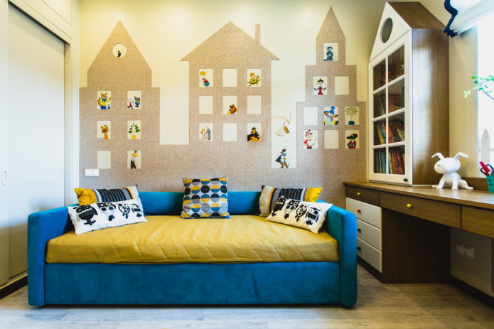 The wall is decorated with houses cut out of self-adhesive wallpaper