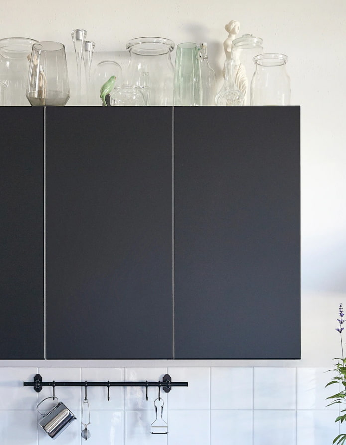 Glass jars and bottles on cabinets