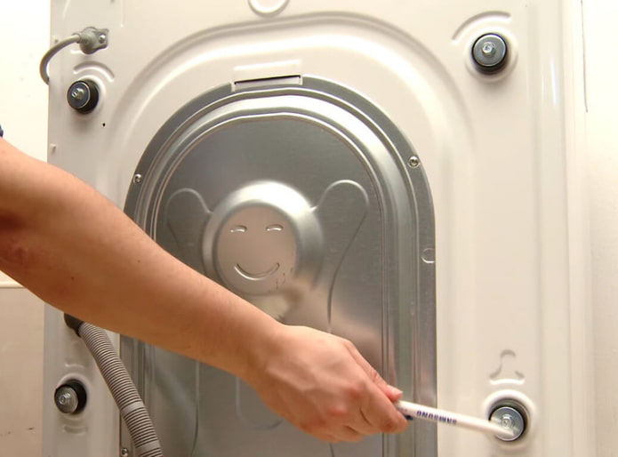 Removing the shipping bolts from the washing machine