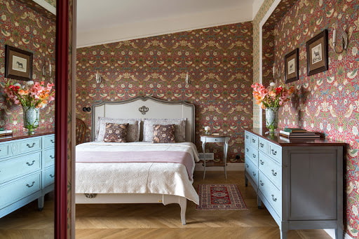 large chest of drawers on the side of the bed