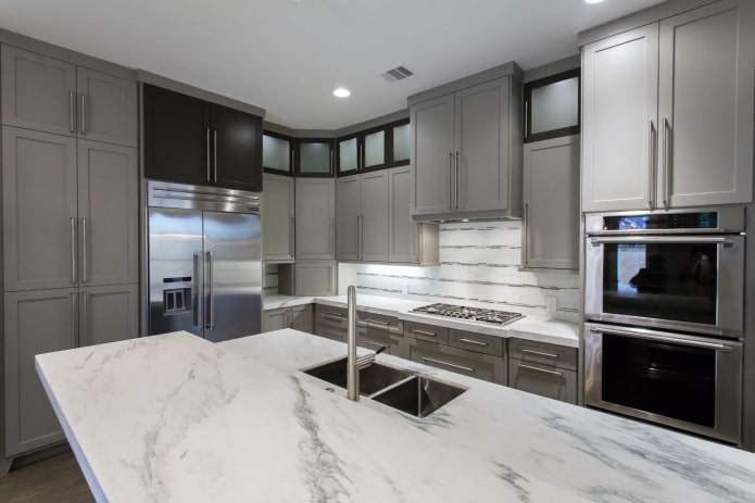 kitchen with light gray furniture and white stone countertops
