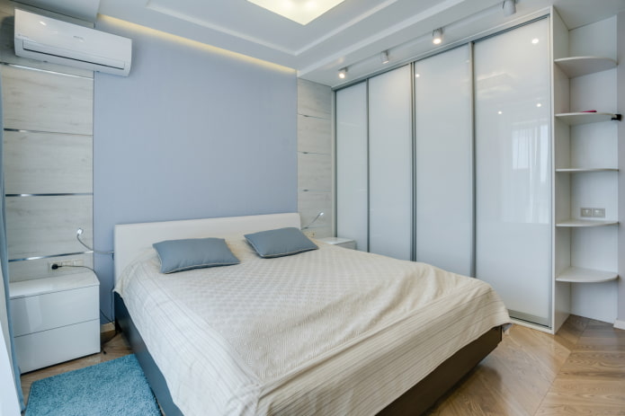 white-colored sliding-door wardrobe in a bedroom interior