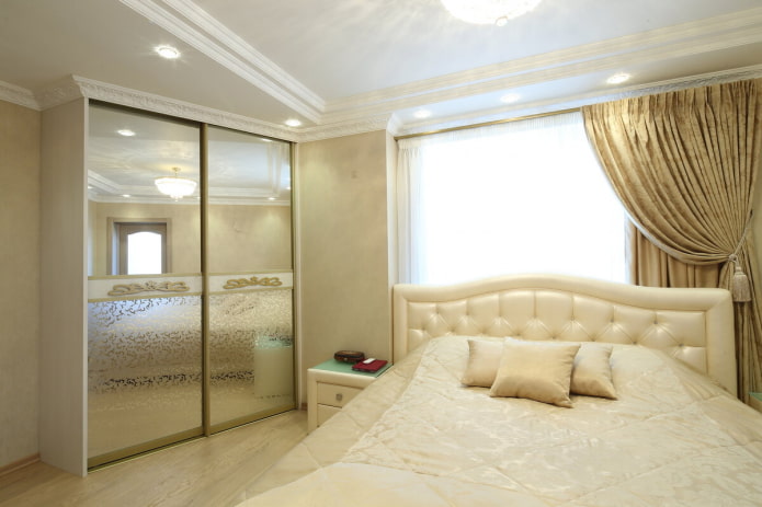 wardrobe with mirrored façade in bedroom interior