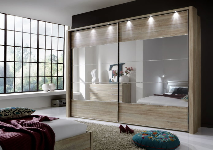 a sliding wardrobe with lighting in the bedroom interior