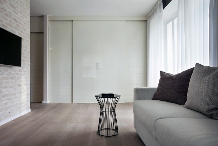 White laconic wardrobe in the living room