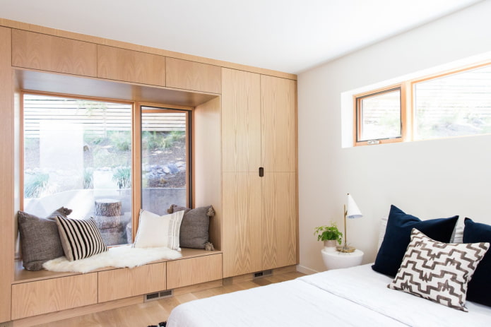cabinets around the window in the bedroom interior