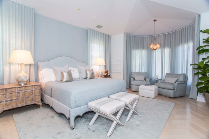 blue curtains on the bay window in the bedroom