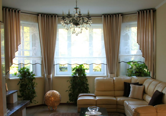 asymmetrical curtains on the bay window in the living room