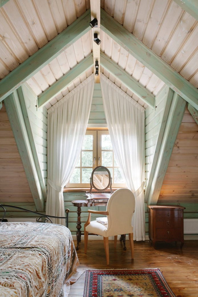 curtains on a dormer window with a slanted ceiling