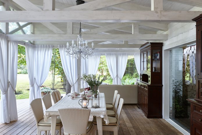 white curtains with grabs on the veranda of a country house