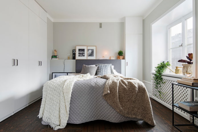 posters at the head of the bed