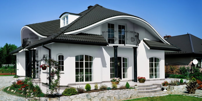 white cottage with a black roof