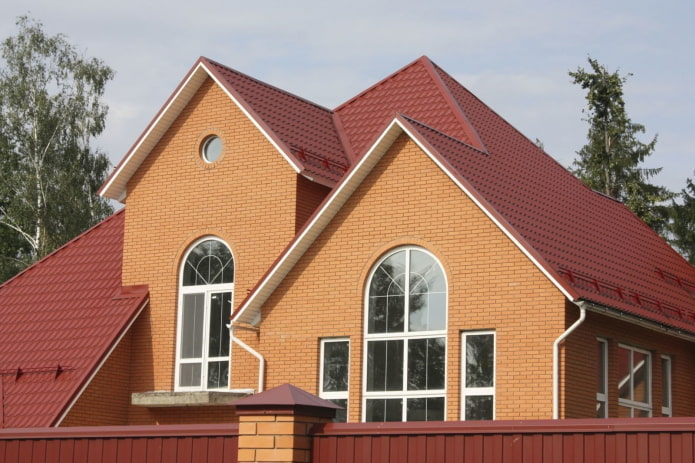 orange brick house with a red roof