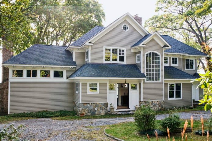 gray house with a dark blue roof