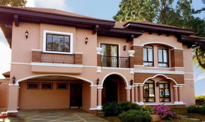 peach-pink house with a burgundy roof