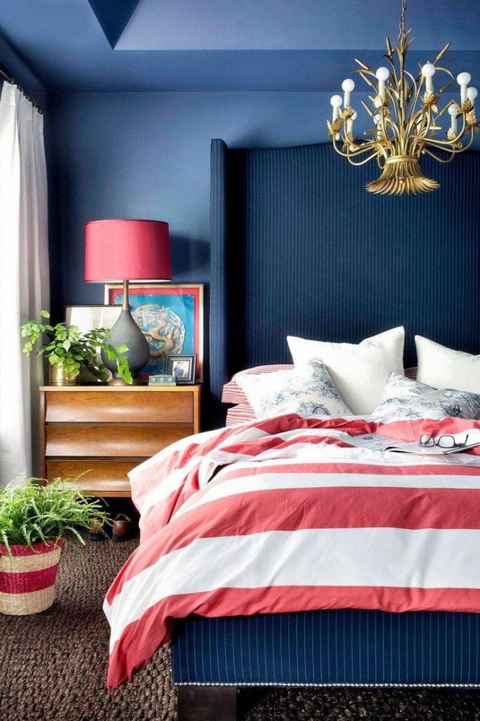 a blue bedroom with red accents