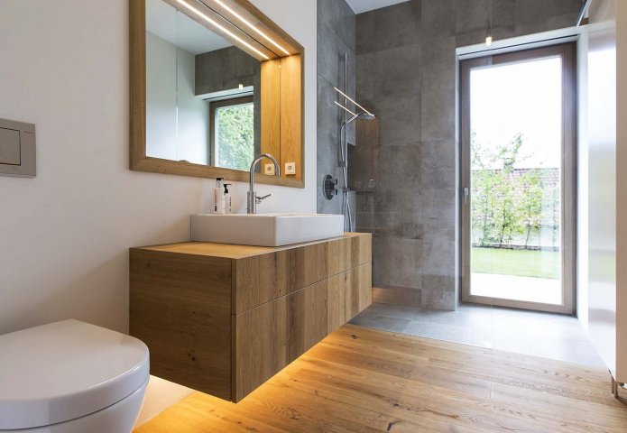 wood-like flooring and furniture in the bathroom