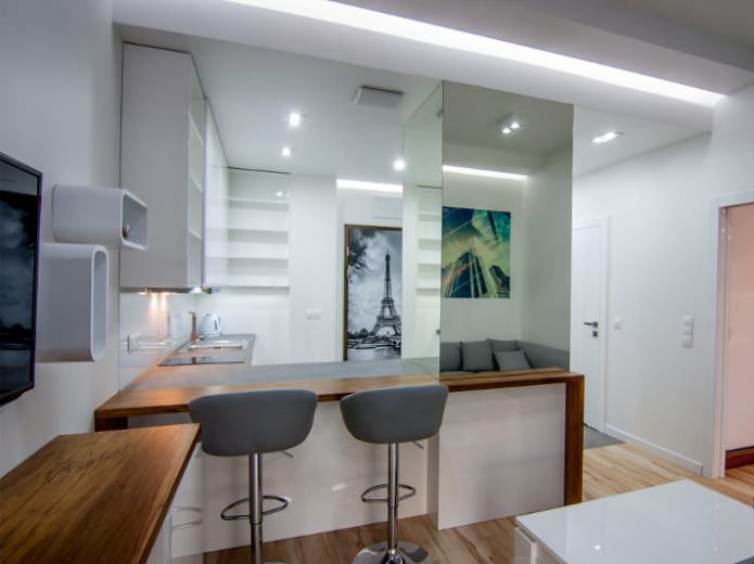 Interior of a combined kitchen-living room with a bar counter