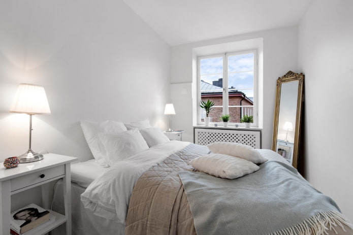 White bedroom with a mirror