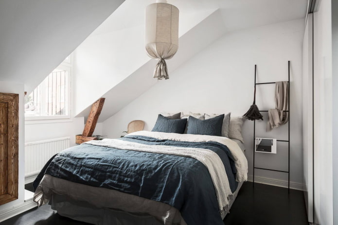 Interior of an attic bedroom in a Scandinavian style