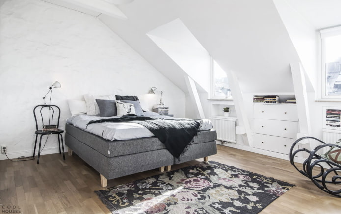 Interior of an attic bedroom in a Scandinavian style