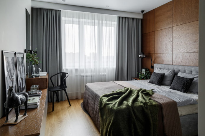 brown headboard with gray curtains and a bed