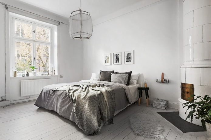 white walls and a gray bed
