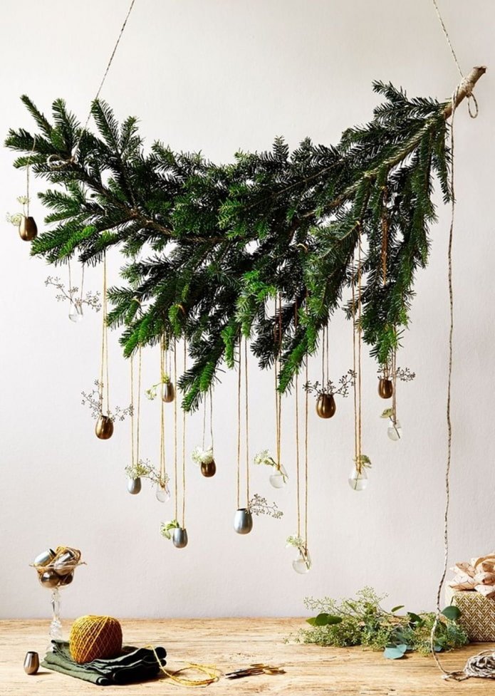 hanging New Year's composition from a spruce branch