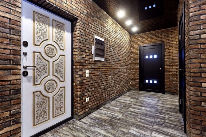 tiles on the floor and brick walls in the hallway