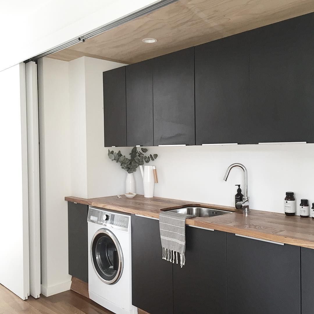 black kitchen with white washing machine