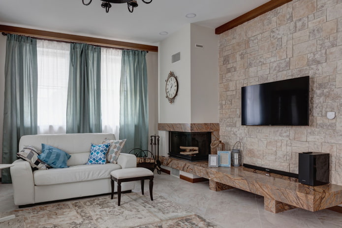 TV on a stone wall in the hall