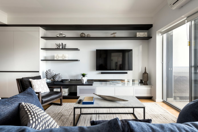 TV on the wall with shelves in the hall